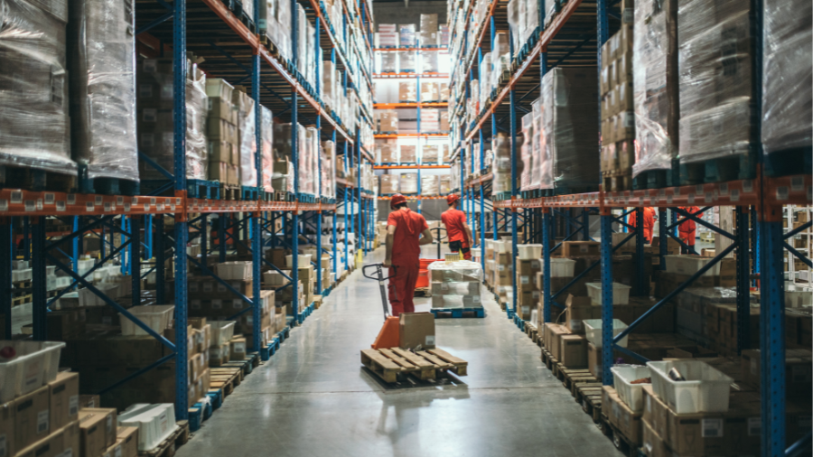 Two warehouse workers picking orders in warehouse